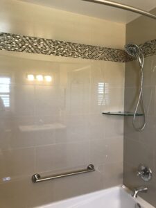 50/50 Brick Lay Tile Pattern on shower walls with corner glass shelving 